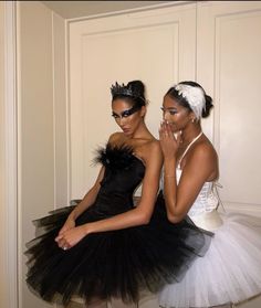 two beautiful young women dressed in black and white