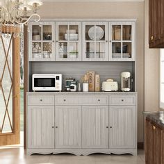 a kitchen area with a microwave and cabinets