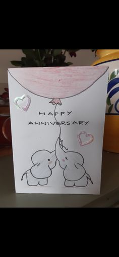 an elephant is giving another elephant a hug on the anniversary card that says happy anniversary