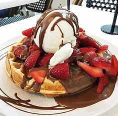 a waffle topped with strawberries and ice cream