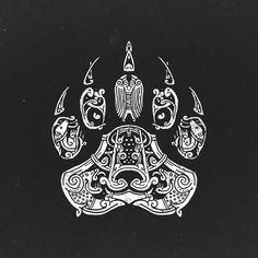 an animal's paw is shown in white ink on black paper with intricate designs