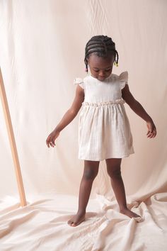 With its %100 Cotton airy double-layered texture , this dress is exactly for summer. It is one of my favorite products that children wear with love. It is very easy to put on and take off thanks to the studs located on the back. The length of the dress is above the knee. Easy to wear. All materials used are Oeko-Tex Certified to protect children's health. It will be sewn immediately after the order has been placed and sent to you no later than 5 working days. Moreover, the little one who is waiting for the sweet girls next to her is also in for a surprise :)   For everyday or special occasions. Composition: 100% cotton Color :  Beige Latte  Available sizes: 2-3 years 3-4 years 5-6 years 7-8 years Made and designed by Siminie in Turkiye. Care instructions: Machine wash at 30o Wash with like Cute Ruffle Hem Dress For The Beach, Cute Ruffle Hem Dress For Beach, Cute Ruffle Dress With Ruffle Hem For Beach, Beige Sleeveless Ruffle Dress For Beach, Beige Ruffled Sleeveless Beach Dress, Beige Sleeveless Dress With Ruffles For Beach, Cute Summer Ruffle Dress For The Beach, Cute Ruffle Dress For Summer Beach, Cute Ruffle Dress For Beach In Summer