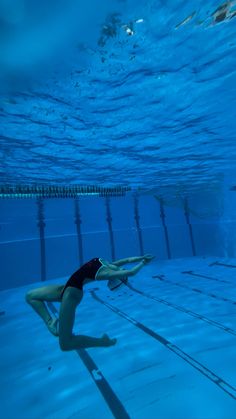 a woman in a swimsuit diving under water