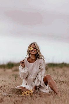 a woman sitting in the middle of a field with food on her face