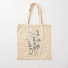 a tote bag with blue flowers and the words be grateful on it's front