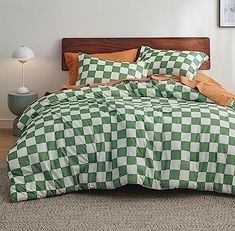 a green and white checkered comforter on a bed