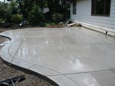 a concrete patio being built in front of a house