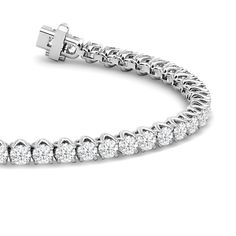 A tennis bracelet displaying a pared-back yet bold aesthetic. This piece features a continuous line of round diamonds set in a decorative tulip basket. This sparkly and elegant piece comes with that little bit of extra style to distinguish itself from the rest. Loose Diamond Bracelets, Tennis Bracelets Diamonds, Tennis Bracelet Aesthetic, Tenis Bracelet, Tulip Basket, Mothers Day Rings, Bold Aesthetic, Diamond Pendants Designs, Round Diamond Setting