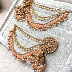 One of our personal favourites!  Antique gold base with champagne zircon crystal. Lightweight jhumka style earrings with detachable ear chains. Stunning peach beads and pearl details  Approximately  Length 3 inch x 1.25 wide inch Ear chains 5 inch length Perfect for a Mendhi function or for a pop of colour Ready to ship! Chains Fashion, Peach Earrings, Peach Colour, Pakistani Style, Ear Chain, Pearl Details, Chain Fashion, Jhumka Earrings, Wedding Jewelry Earrings