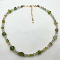 Olive Green Beaded Choker Necklace Earth Tone Beaded Choker Random Beaded Choker Gemstone Glass Beaded Necklace Short Multi Beaded Necklace Summer Beaded Necklace Recycled Beaded Necklace Mid Century Style Necklace Short Beaded Necklace Gift for Her Gift for Mom Gift for Friend Mid Century design Olive Green and Brown Glass Glass Gemstone Beaded Choker Necklace with Lobster Claw Closure and 3 inch Extender Chain.  DETAILS OF THE NECKLACE:   *Random Beads sizes 4mm to 8mm: -Various Shapes and Sizes Olive Green Glass Beads recycled from a vintage necklace   -Natural Moon Stone Crystal Quartz Beads  -Frosted Beige Glass Beads *Closure:  Lobster Claw with 3 inch/7.62 centimetre Extender Chain *Necklace Measurement: 15.75  inches/ 40 centimetres  with extender chain 18.75 inches/ 47.62 centimet Earthy Green Beaded Necklace With Gemstone Beads, Earth Tone Beaded Necklace, Earthy Green Jewelry With 8mm Beads, Handmade Green Multi-strand Beaded Necklaces, Short Beaded Necklace, Vintage Multi-strand Green Beaded Necklaces, Summer Necklace, Beaded Choker Necklace, Glass Bead Necklace