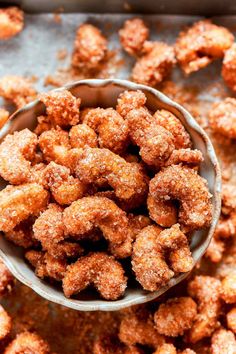 a small bowl filled with sugar coated doughnuts