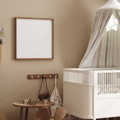 a baby's room with a crib, table and chair