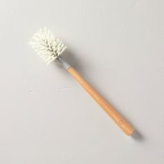 a close up of a toothbrush on a white surface