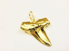 This vermeil  shark tooth is a nice piece for necklaces, bracelets and earrings. It measures about 22x15mm including loop. It is 18k gold plated over 925 sterling silver (vermeil), shiny finished.1 pc. SILVER VERSION:  https://www.etsy.com/listing/219670150/925-sterling-silver-oxidized-shark-toothMATTE VERMEIL VERSION:   https://www.etsy.com/listing/242934154/vermeil-18k-gold-over-925-sterlingSHINY ROSE GOLD VERSION:   https://www.etsy.com/listing/464997918/rose-gold-vermeil-18k-rose-gold-over-9 Gold Arrowhead Jewelry Gift, Gold Arrowhead Jewelry For Gift, Silver Shark, Tooth Charm, Shark Tooth, Shark Teeth, 18k Rose Gold, Gold Vermeil, Necklaces Bracelets