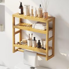 a wooden shelf with soaps, lotions and other items on it in a bathroom