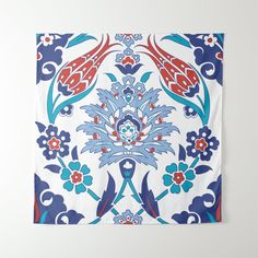 a blue and red floral design on a white wall hanging from a hook with hooks