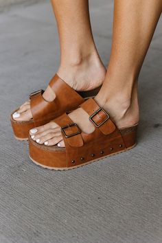 Level up your sandal game with these platform stunners!  They've got a sleek faux leather upper that looks polished but feels comfy, and a molded footbed that cradles your feet all day long. The platform sole adds some height without feeling clunky, and the adjustable buckle straps ensure a perfect fit.  Dress them up or down, these sandals are ready to take you from brunch dates to rooftop hangs and anywhere in between.  Basically, your feet are gonna be thanking you for these! Faux leather upper Molded footbed Platform sandals Adjustable buckle straps Fit true to size Brunch Dates, Platform Flip Flops, Leather Platform Sandals, Fit Dress, The Platform, Platform Sandals, Cognac, Brown Leather, Dates