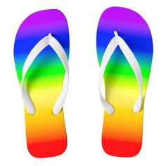 a pair of rainbow colored flip flops with white soles on a white background