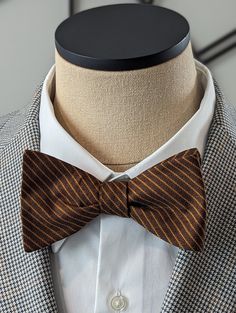 Elevate your style with this exquisite Brown Stripe Bow Tie. Handcrafted with precision and attention to detail, this custom self-tie bow tie is the perfect accessory to add a touch of sophistication to your outfit. Featuring a classic stripe pattern, this bow tie is versatile and can be paired effortlessly with both casual and conservative attire. Whether you're attending a business meeting or a social event, this bow tie will instantly elevate your look and make a lasting impression. Made from high-quality materials, this Brown Stripe Bow Tie is not only stylish but also durable, ensuring that it will last for years to come. The self-tie design allows for the perfect fit and gives you the freedom to adjust it according to your preference. With its timeless appeal, this bow tie is a must- Luxury Classic Bow Tie, Luxury Satin Bow Tie For Semi-formal Occasions, Classic Striped Ties For Black Tie Events, Classic Striped Tie For Black Tie Events, Classic Striped Tie For Black Tie Occasions, Elegant Striped Suit And Tie Accessories For Black Tie, Classic Pre-tied Bow Tie, Classic Pre-tied Bow With Ties, Classic Pre-tied Bow