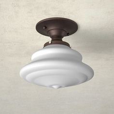 a ceiling light with a white glass shade