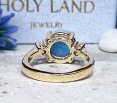 Don't miss this opportunity to own this beautiful gemstone ring crafted in 14k gold filled => Gemstone Type - Opal, Clear Quartz => Gemstone Cut - Cabochon, Faceted => Gemstone Size - 10 mm, 3 mm => Total Number of Gemstones - 3 => Metal Type - 14k Gold Filled (Tarnish Resistant And Nickel Free) - also available in 925 sterling silver * Please contact me for pricing on a sizes larger than 11 * ~ Feel free to ask me about custom made designs. ❏ Replacements and custom orders : ✪ 92 Adjustable Yellow Gold Opal Ring For Anniversary, Gold Opal Jewelry With Prong Setting, Gold Opal Ring With Accent Stones In 14k Gold, Gold Opal Ring With Diamond Accent Stones, 14k Gold Opal Ring With Accent Stones, Gold Emerald Ring With Round Center Stone, 14k Gold Halo Ring With Accent Stones For Promise, Gold Opal Ring With Prong Setting As Gift, Gold Opal Ring With Accent Stones For Anniversary