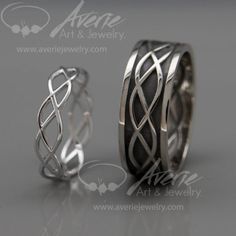 two wedding bands made out of silver and black ceramic, one with an intertwined design