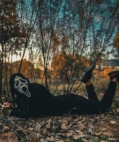 a person laying on the ground with their feet in the air and wearing a mask