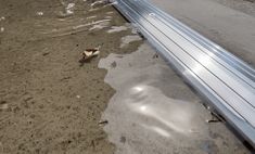 an empty street with puddles of water on the ground