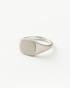 Mens Engravable Signet Ring | Sterling Silver. Handcrafted for Him. The Classic Signet Ring in Sterling Silver is Upgraded with a Brushed Finish and Rounded Edges, Plus It Can be Engraved on Top and on the Band's Outer Sides. Pair with a Chunky Chain Bracelet for a Statement Look. Please Note: Engraving Items May Take 7-10 Working Days to Process. Metal: Rhodium Plated on Recycled Sterling Silver Dimensions: 12. 5mm X 11. 5mm Weight: 7. 5g Product Code: Mj-S-R4-Ns Silver Engraved Metal Signet Ring, Silver Platinum Polished Signet Ring, Silver Sterling Silver Signet Ring, Tarnish Resistant, Silver Stainless Steel Signet Ring With Polished Finish, Formal Sterling Silver Signet Ring With Hallmarks, Double Chain Necklace, Gold And Silver Rings, Demi Fine Jewelry, Gold Price