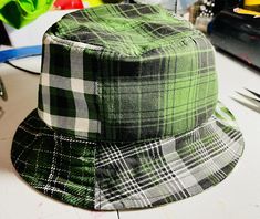 Mixed green plaid bucket hat. 23 inches around. Casual Wide Brim Plaid Hat, Casual Plaid Hat With Curved Brim, Spring Plaid Hat With Curved Brim, Plaid Adjustable Curved Brim Hat, Adjustable Plaid Hat With Curved Brim, Green Reversible Bucket Hat With Curved Brim, Green Reversible Bucket Hat With Short Brim, Green Reversible Short Brim Bucket Hat, Green Reversible Curved Brim Bucket Hat