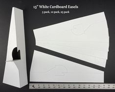 white cardboard easels are cut and placed next to a ruler