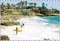 people are walking on the beach with surfboards in hand and one person is carrying a yellow surfboard