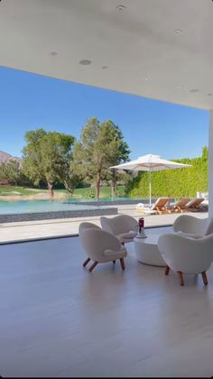 a living room with white furniture and an open patio