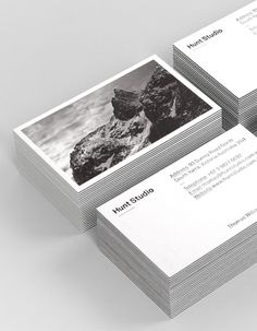 four business cards stacked on top of each other with black and white photos in them