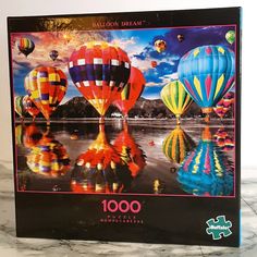 a jigsaw puzzle with hot air balloons in the sky