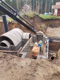 construction workers are working on an underground pipe