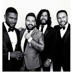 three men in tuxedos are posing for the camera