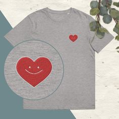 Discover the heart embroidered t-shirt, a perfect basic with a touch of originality. This is a short sleeve, round neck t-shirt made from heavyweight organic cotton. Its soft fabric and slightly fitted cut make it a very comfortable t-shirt that is suitable for both men and women. It is embroidered with a smiling heart design embroidered on the left chest. The embroidery is made up of red and white threads. Unisex t-shirt available in navy blue and black. One of the advantages of embroidery is t Relaxed Fit Cotton T-shirt As Gift, Cotton Graphic Tee With Heart Patch, Cotton T-shirt With Heart Patch, Short Sleeve, Cotton T-shirt With Heart Patch Short Sleeve, Cotton T-shirt With Heart Patch, Red Short Sleeve T-shirt With Embroidered Text, Embroidered Crew Neck T-shirt Gift, Cotton Tops With Embroidered Logo, Cotton Tops With Embroidered Logo For Gift