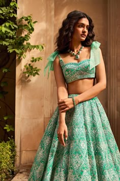 This lehenga set features a multi-layered net lehenga with different shades of seagreen and is appliqued in a geometric pattern. The skirt is paired with a blouse with a bow tie on the shoulder.From Seema Gujral's Lumiere collection DELIVERY TIMEPlease allow 8-12 weeks for your outfit to arrive. FABRIC DETAILSNet. Professional cleaning only. Weddings 2024, Seema Gujral, Indian Outfits Lehenga, Wedding Lehenga Designs, Dresses Traditional, Lehenga Designs Simple, Green Lehenga, Traditional Indian Dress, Net Lehenga