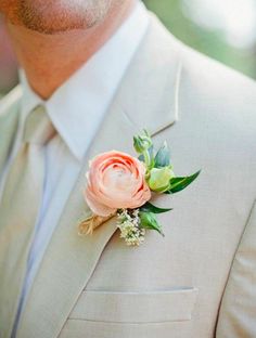 a man in a suit with a boutonniere on his lapel