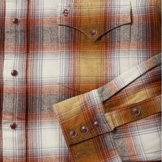 This rugged snap-front flannel shirt features an exclusive rust plaid pattern along with classic western style details like a one-point curved back yoke and a three-snap roper cuff. Crafted from a 100% cotton twill flannel that has been yarn-dyed for rich, lasting color and brushed for a soft appearance, the shirt is garment washed, giving it the lived-in feel of an old favorite that will break in further over time. It has a spread collar with collar stays to keep it in place and is cut in our O Brown Button Closure Flannel Shirt, Brown Flannel Shirt With Button Closure, Fall Plaid Flannel Shirt For Rodeo, Western Style Plaid Flannel Shirt For Ranch, Rugged Plaid Flannel Shirt For Fall, Plaid Flannel Shirt For Rodeo In Fall, Plaid Long Sleeve Western Flannel Shirt, Western Style Long Sleeve Plaid Flannel Shirt, Western Plaid Flannel Shirt For Rodeo