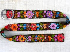 "Peruvian embroidered belt floral colorful These belts are densely embroidered using dozens of colors naturals and each one is unique. Elegant floral design and a pleasure to wear, it will bring joy to you through its visual beauty as you will want to wear it time and time again. Each belt 5 sets of holes spaced 2\" apart so they are versatile. You can wear the same belt on your waist or hips. They also stretch slightly, like a pair of jeans, and will conform to your body after a few days of wea Adjustable Embroidered Multicolor Belts, Adjustable Multicolor Embroidered Belts, Handmade Bohemian Belts As Gift, Multicolor Fabric Belt In Folk Style, Handmade Bohemian Belt With Multicolor Embroidery, Folk Style Multicolor Fabric Belt, Multicolor Folk Fabric Belt, Handmade Multicolor Belt For Festivals, Bohemian Multicolor Embroidered Belt