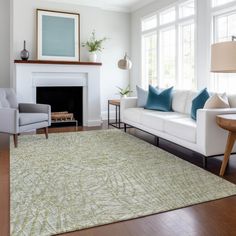 a living room filled with furniture and a fire place next to a white couch in front of a fireplace