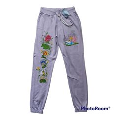 Authentic Brand New With Tag Unused. Ship With Care,Photos Taken From Actual Item. Note: Brand New. Mx Q47 If You're Planning On Spending Your Golden Afternoons Indoors, These Are The Perfect Bottoms To Get Cozy In! These Lavender Sweatpants Have A Print Of Alice Napping With Dinah On The Left Leg And The Flowers Of Wonderland On The Right. Features A Drawstring Waist And Tapered Ankles. 100% Cotton Wash Cold; Dry Low Drawstring Waist Tapered Ankles Imported Sold As Pictured! Please Look At The Disney Cotton Pants For Loungewear, Disney Cotton Loungewear Pants, Wonderland Flowers, Alice In Wonderland Flowers, Disney Alice In Wonderland, Pj Pants, Disney Alice, Getting Cozy, Hot Topic