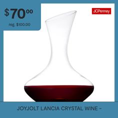 a wine decanter sitting on top of a table next to a blue background