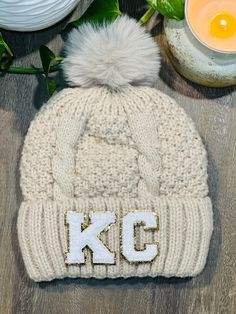 Super cute lined creamy beige pom beanie with chenille KC letters. The letters are not attached in the photos but will be once the order is placed. One size fits most. Colors may vary due to individual monitor settings on your computer or device. Chunky Beanie, Pom Beanie, Skull Cap Beanie, Fan Gear, Skull Cap, Caps Hats, Accessories Hats, Winter Hats, Pom Pom