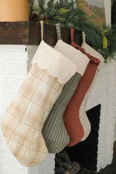 three christmas stockings hanging from a mantel