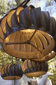 an old fashioned light fixture hanging from a tree