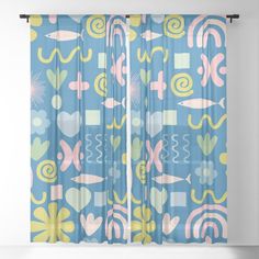 a blue curtain with pink, yellow and green abstract designs on the outside of it