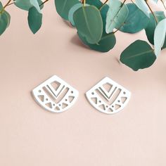 Introducing the Myra Stud Earrings! These pretty little sterling silver earrings are perfect for adding a touch of bohemian chic to any look. They feature a geometric triangle design with aztec-inspired cut outs in the center. The simple silver stud design makes them easy to wear with anything, and they look great alone or teamed with other studs for a stacked look. Whether you're dressing up or dressing down, these earrings are sure to add a touch of style. So go ahead and show your unique sens White Triangle Earrings For Gift, White Bohemian Geometric Earrings, White Geometric Bohemian Earrings, Bohemian White Geometric Earrings, Golden Jewelry, Triangle Design, Geometric Triangle, Bohemian Chic, Silver Studs